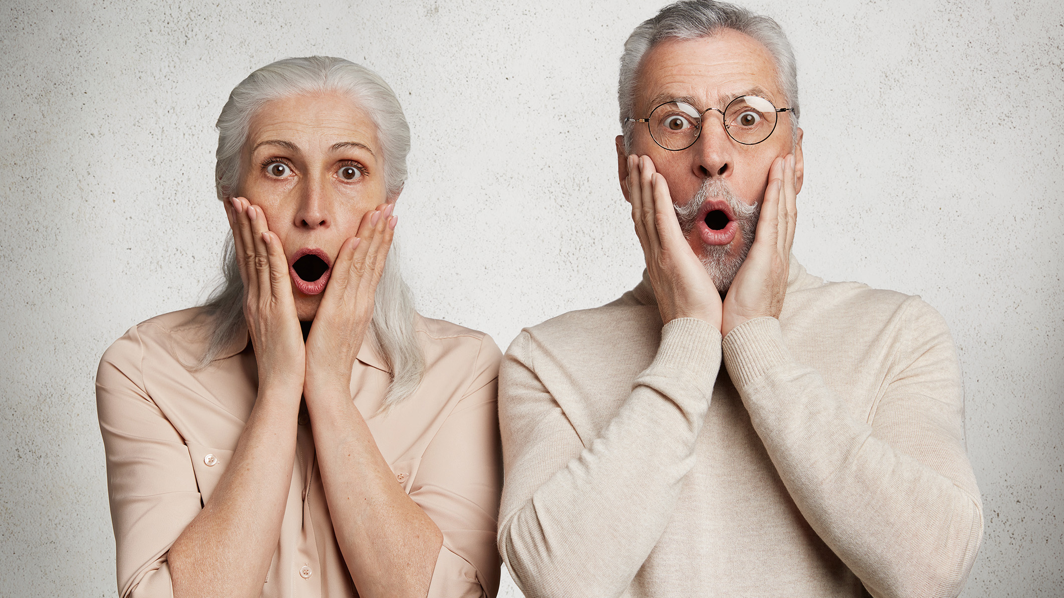 Elderly female and male stare at camera with terrified expressions when they realize they need to make healthy changes to their lifestyle